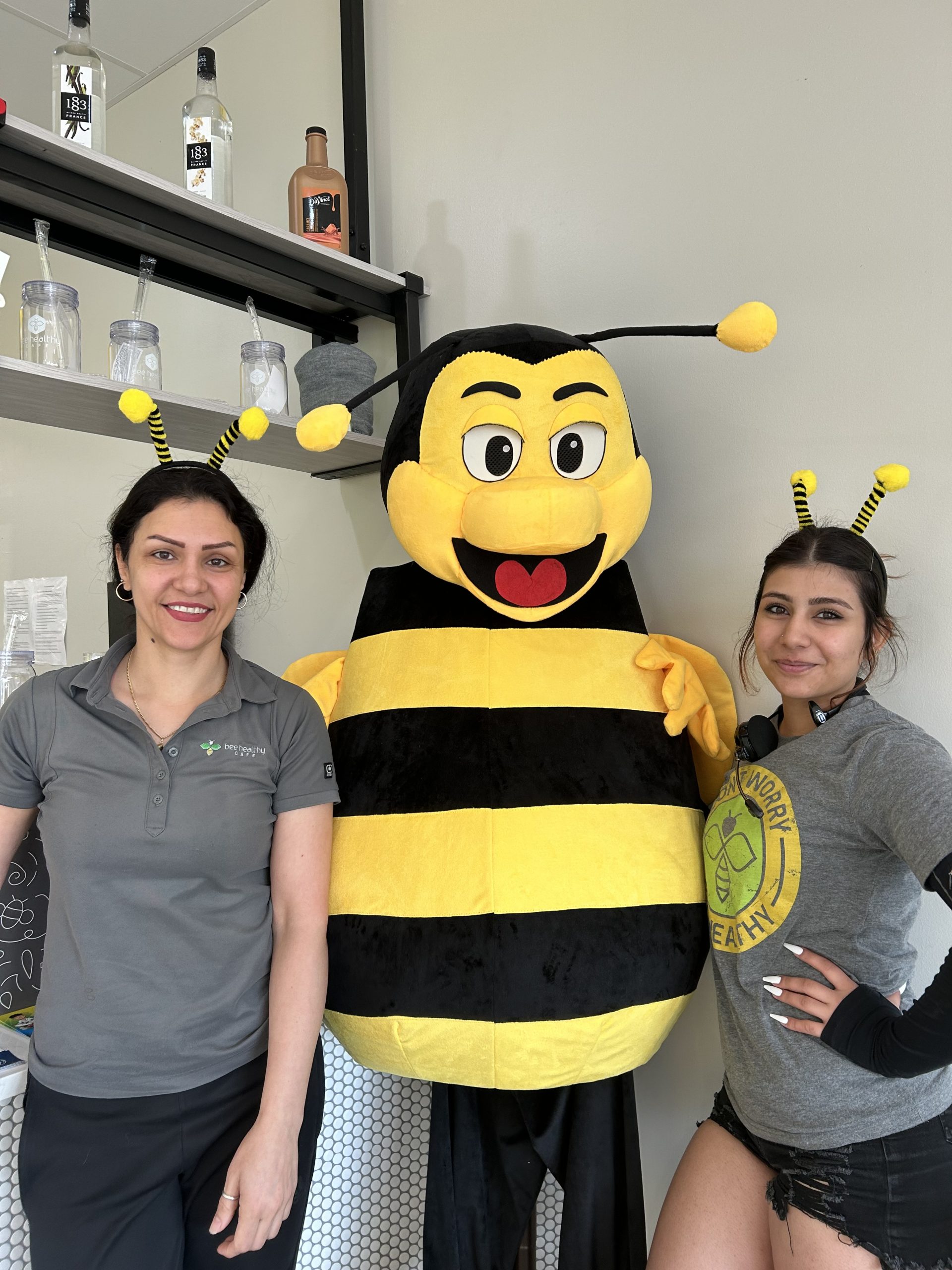 Franchisee posing with her daughter and the Bee Healthy Mascot
